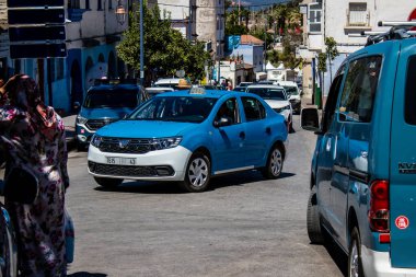 Tetouan, Morocco - August 17, 2022 Taxi driving through the streets of Tetouan during the coronavirus outbreak hitting Morocco, wearing a mask is mandatory
