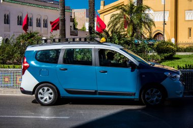 Tetouan, Morocco - August 17, 2022 Taxi driving through the streets of Tetouan during the coronavirus outbreak hitting Morocco, wearing a mask is mandatory