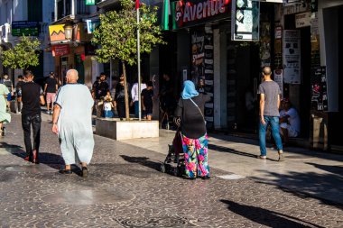 Tetouan, Morocco - August 18, 2022 Arabic people walking in the busy street of Tetouan, the city has a narrow and winding Arabic layout typical of oriental cities