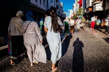 Tetouan, Morocco - August 18, 2022 Arabic people walking in the busy street of Tetouan, the city has a narrow and winding Arabic layout typical of oriental cities