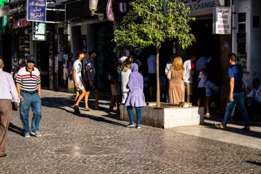 Tetouan, Morocco - August 18, 2022 Arabic people walking in the busy street of Tetouan, the city has a narrow and winding Arabic layout typical of oriental cities