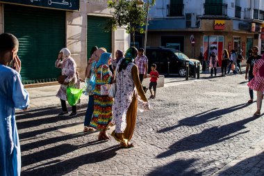 Tetouan, Morocco - August 18, 2022 Arabic people walking in the busy street of Tetouan, the city has a narrow and winding Arabic layout typical of oriental cities