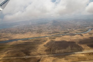 Seville, Spain - August 19, 2022 Commercial flight between the city of Seville in Spain and Tetouan in Morocco, View from the sky of the land and the Strait of Gibraltar separating Europe and Africa