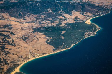 Seville, Spain - August 19, 2022 Commercial flight between the city of Seville in Spain and Tetouan in Morocco, View from the sky of the land and the Strait of Gibraltar separating Europe and Africa