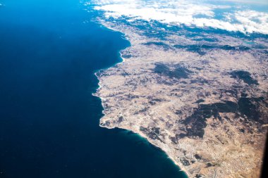 Seville, Spain - August 19, 2022 Commercial flight between the city of Seville in Spain and Tetouan in Morocco, View from the sky of the land and the Strait of Gibraltar separating Europe and Africa