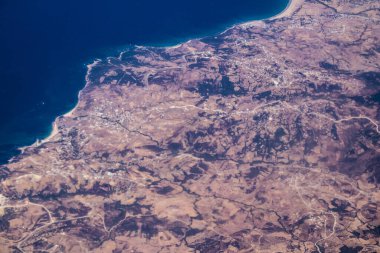 Seville, Spain - August 19, 2022 Commercial flight between the city of Seville in Spain and Tetouan in Morocco, View from the sky of the land and the Strait of Gibraltar separating Europe and Africa