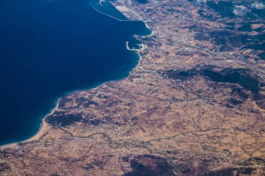 Seville, Spain - August 19, 2022 Commercial flight between the city of Seville in Spain and Tetouan in Morocco, View from the sky of the land and the Strait of Gibraltar separating Europe and Africa