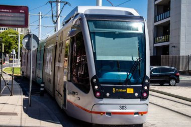 Seville, Spain - September 01, 2022 Modern electric tram for passengers rolling through the streets of Seville during the coronavirus outbreak hitting Spain, wearing a mask is mandatory