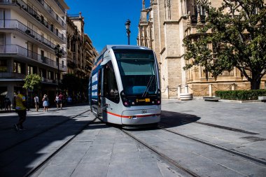 Seville, Spain - September 01, 2022 Modern electric tram for passengers rolling through the streets of Seville during the coronavirus outbreak hitting Spain, wearing a mask is mandatory