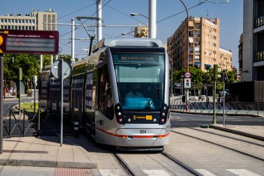 Seville, Spain - September 01, 2022 Modern electric tram for passengers rolling through the streets of Seville during the coronavirus outbreak hitting Spain, wearing a mask is mandatory