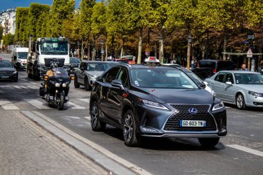 Paris, France - September 05, 2022 Taxi driving through the streets of Paris, This mode of transport is famous and widely used by Parisians and tourists, several companies compete in the city of Paris