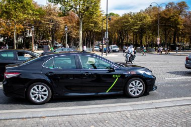 Paris, France - September 05, 2022 Taxi driving through the streets of Paris, This mode of transport is famous and widely used by Parisians and tourists, several companies compete in the city of Paris