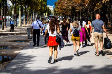 Paris, France - September 05, 2022 Tourists strolling down the famous Avenue Des Champs Elysee in Paris during the coronavirus epidemic which is hitting France, wearing a mask is not mandatory