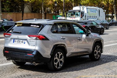 Paris, France - September 05, 2022 Taxi driving through the streets of Paris, This mode of transport is famous and widely used by Parisians and tourists, several companies compete in the city of Paris