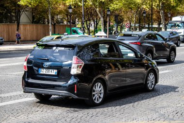 Paris, France - September 05, 2022 Taxi driving through the streets of Paris, This mode of transport is famous and widely used by Parisians and tourists, several companies compete in the city of Paris