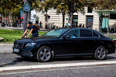 Paris, France - September 05, 2022 Taxi driving through the streets of Paris, This mode of transport is famous and widely used by Parisians and tourists, several companies compete in the city of Paris