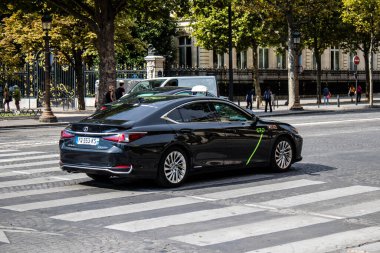 Paris, France - September 05, 2022 Taxi driving through the streets of Paris, This mode of transport is famous and widely used by Parisians and tourists, several companies compete in the city of Paris
