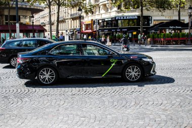 Paris, France - September 05, 2022 Taxi driving through the streets of Paris, This mode of transport is famous and widely used by Parisians and tourists, several companies compete in the city of Paris