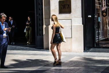 Paris, France - September 05, 2022 Tourists strolling down the famous Avenue Des Champs Elysee in Paris during the coronavirus epidemic which is hitting France, wearing a mask is not mandatory