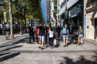 Paris, France - September 05, 2022 Tourists strolling down the famous Avenue Des Champs Elysee in Paris during the coronavirus epidemic which is hitting France, wearing a mask is not mandatory