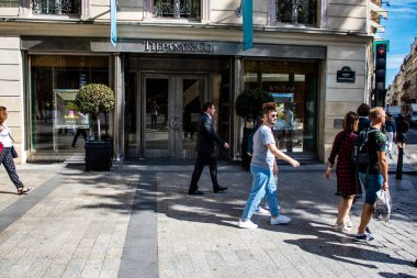 Paris, France - September 05, 2022 Tourists strolling down the famous Avenue Des Champs Elysee in Paris during the coronavirus epidemic which is hitting France, wearing a mask is not mandatory