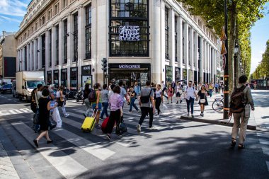 Paris, France - September 05, 2022 Tourists strolling down the famous Avenue Des Champs Elysee in Paris during the coronavirus epidemic which is hitting France, wearing a mask is not mandatory