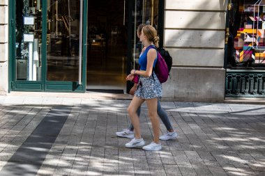 Paris, France - September 05, 2022 Tourists strolling down the famous Avenue Des Champs Elysee in Paris during the coronavirus epidemic which is hitting France, wearing a mask is not mandatory