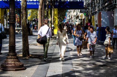 Paris, France - September 05, 2022 Tourists strolling down the famous Avenue Des Champs Elysee in Paris during the coronavirus epidemic which is hitting France, wearing a mask is not mandatory