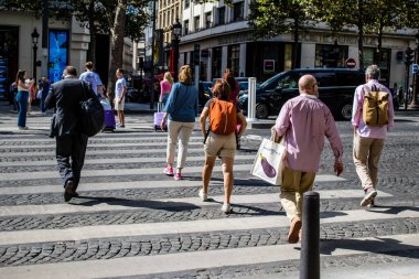 Paris, France - September 05, 2022 Tourists strolling down the famous Avenue Des Champs Elysee in Paris during the coronavirus epidemic which is hitting France, wearing a mask is not mandatory