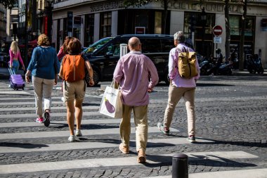 Paris, France - September 05, 2022 Tourists strolling down the famous Avenue Des Champs Elysee in Paris during the coronavirus epidemic which is hitting France, wearing a mask is not mandatory