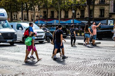 Paris, France - September 05, 2022 Tourists strolling down the famous Avenue Des Champs Elysee in Paris during the coronavirus epidemic which is hitting France, wearing a mask is not mandatory