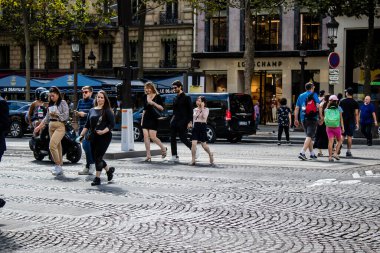 Paris, France - September 05, 2022 Tourists strolling down the famous Avenue Des Champs Elysee in Paris during the coronavirus epidemic which is hitting France, wearing a mask is not mandatory