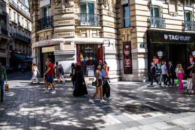 Paris, France - September 05, 2022 Tourists strolling down the famous Avenue Des Champs Elysee in Paris during the coronavirus epidemic which is hitting France, wearing a mask is not mandatory