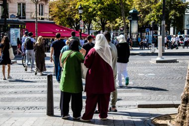 Paris, France - September 05, 2022 Tourists strolling down the famous Avenue Des Champs Elysee in Paris during the coronavirus epidemic which is hitting France, wearing a mask is not mandatory
