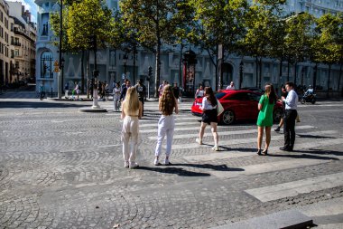 Paris, France - September 05, 2022 Tourists strolling down the famous Avenue Des Champs Elysee in Paris during the coronavirus epidemic which is hitting France, wearing a mask is not mandatory