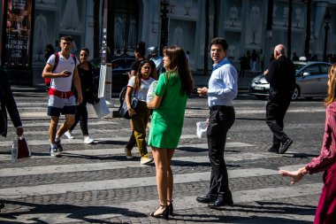 Paris, France - September 05, 2022 Tourists strolling down the famous Avenue Des Champs Elysee in Paris during the coronavirus epidemic which is hitting France, wearing a mask is not mandatory
