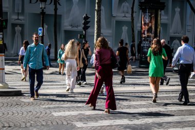 Paris, France - September 05, 2022 Tourists strolling down the famous Avenue Des Champs Elysee in Paris during the coronavirus epidemic which is hitting France, wearing a mask is not mandatory