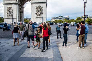 Paris, France - September 05, 2022 Tourists strolling down the famous Avenue Des Champs Elysee in Paris during the coronavirus epidemic which is hitting France, wearing a mask is not mandatory
