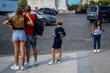 Paris, France - September 05, 2022 Tourists strolling down the famous Avenue Des Champs Elysee in Paris during the coronavirus epidemic which is hitting France, wearing a mask is not mandatory
