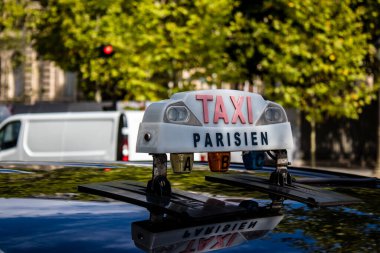 Paris, France - September 05, 2022 Taxi driving through the streets of Paris, This mode of transport is famous and widely used by Parisians and tourists, several companies compete in the city of Paris