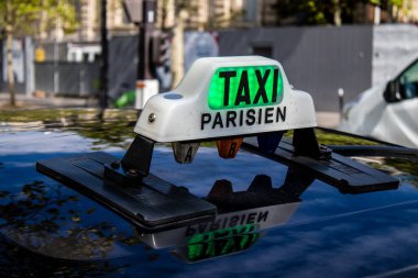 Paris, France - September 05, 2022 Taxi driving through the streets of Paris, This mode of transport is famous and widely used by Parisians and tourists, several companies compete in the city of Paris