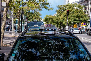Paris, France - September 05, 2022 Taxi driving through the streets of Paris, This mode of transport is famous and widely used by Parisians and tourists, several companies compete in the city of Paris