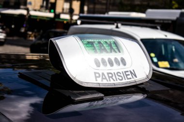 Paris, France - September 05, 2022 Taxi driving through the streets of Paris, This mode of transport is famous and widely used by Parisians and tourists, several companies compete in the city of Paris