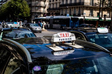 Paris, France - September 05, 2022 Taxi driving through the streets of Paris, This mode of transport is famous and widely used by Parisians and tourists, several companies compete in the city of Paris