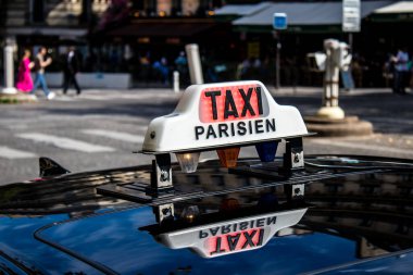 Paris, France - September 05, 2022 Taxi driving through the streets of Paris, This mode of transport is famous and widely used by Parisians and tourists, several companies compete in the city of Paris