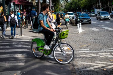 Paris, France - September 05, 2022 People cycling on the streets, bicycles are widely used by Parisians and tourists, many cycle paths are available in the capital to promote this mode of transport