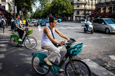 Paris, France - September 05, 2022 People cycling on the streets, bicycles are widely used by Parisians and tourists, many cycle paths are available in the capital to promote this mode of transport