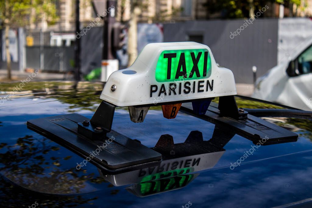 Paris, France - September 05, 2022 Taxi driving through the streets of Paris, This mode of transport is famous and widely used by Parisians and tourists, several companies compete in the city of Paris