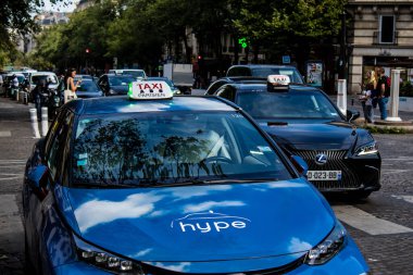 Paris, France - September 05, 2022 Taxi driving through the streets of Paris, This mode of transport is famous and widely used by Parisians and tourists, several companies compete in the city of Paris