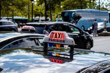 Paris, France - September 05, 2022 Taxi driving through the streets of Paris, This mode of transport is famous and widely used by Parisians and tourists, several companies compete in the city of Paris